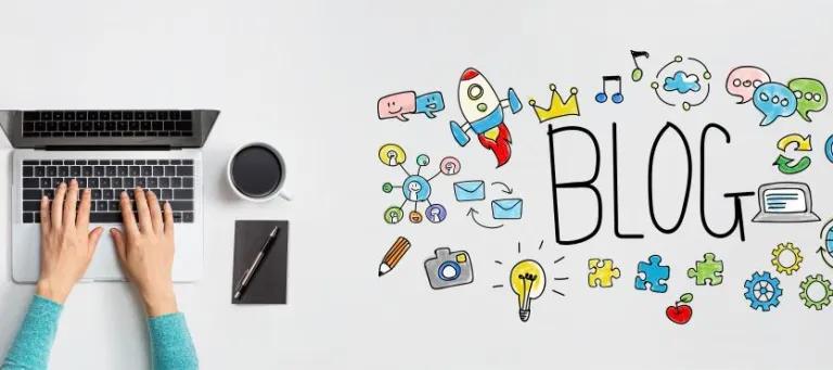 Person writing on laptop, with a blog illustration on the table