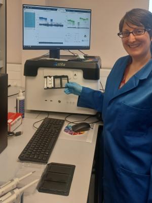 A picture of a technician standing by the Stilla Technologies Naica digital PCR platform